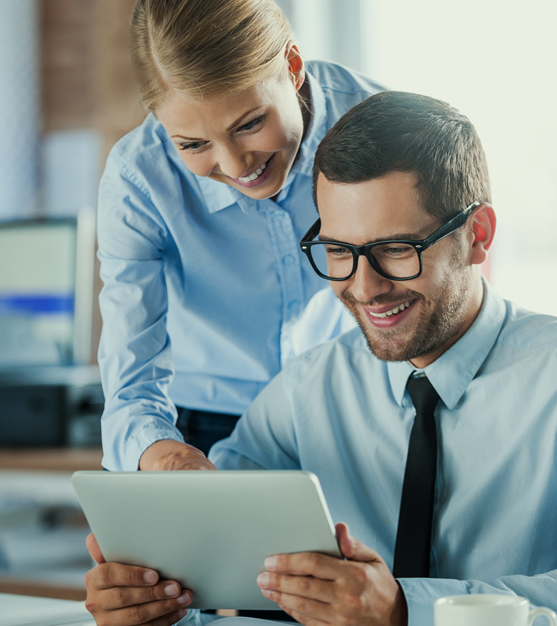 Two colleagues discussing project over tablet