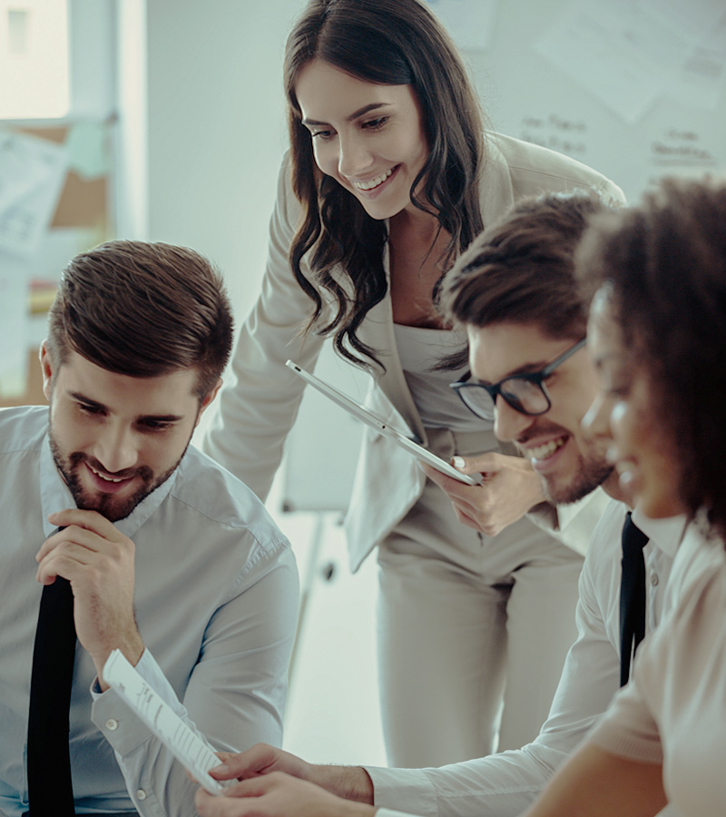 Group of employees collaborating and looking at papers